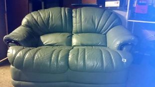 A green leather 2 seater sofa