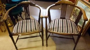 A pair of mahogany elbow chairs