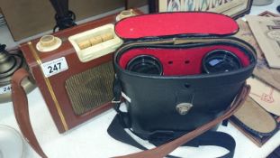A pair of binoculars with a/f case and a portable radio