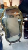 A gilt framed easel mirror
