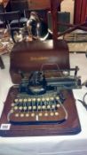 A Blickensderfer portable typewriter in wooden case
 
The carriage does move smoothly & type wheel