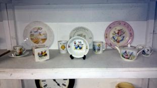 A collection of nursery ware including Grimwades Peter Rabbit teapot/milk jug, Sooty,