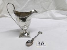 A Georgian silver jug and a white metal Dutch souvenir spoon