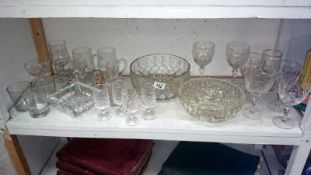 A shelf of assorted glassware