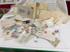 A collection of loose stamps, early stamped envelopes,