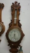 An oak barometer by Heath & Co., Ltd.