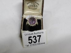 An 18ct gold oval amethyst and diamond ring,