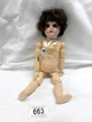 A Victorian porcelain headed doll with composition body