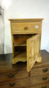 A pine bedside cabinet