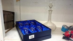 A boxed set of 6 cut glass wine glasses and a decanter