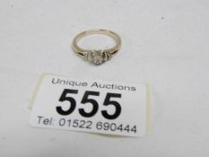 A 9ct gold ring with 2 diamonds on shoulders,