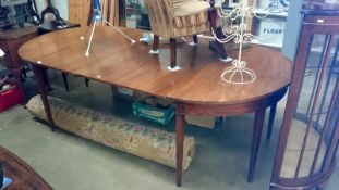 An oval extending dining table