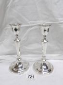 A pair of silver candlesticks,