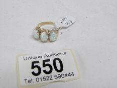 A large 3 stone yellow gold and opal ring,
