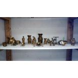 A shelf of assorted brass ornaments