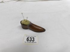 A 19th century wooden shoe as a pin cushion