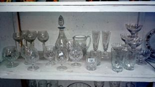 A shelf of assorted glass ware