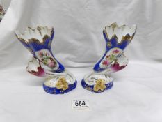 A pair of cornucopia shaped vases