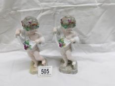 A pair of 19th century continental porcelain cherub figures
