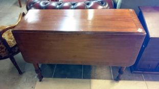 A mahogany drop leaf table