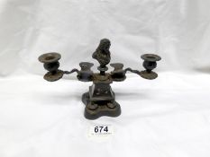 An unusual old metal candle holder