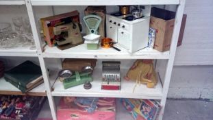 3 shelves of vintage toys including Amersham tin cooker,