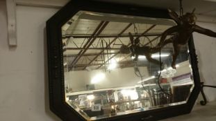 An oak framed bevel edged mirror