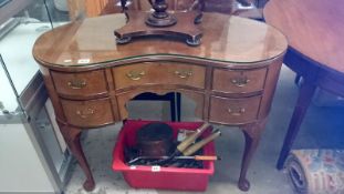 A kidney shaped dressing  table