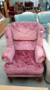 A pink wing arm chair