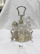 A 4 bottle glass cruet on plated stand