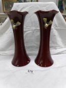 A pair of unusual Bretby vases decorated with applied moths