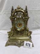 An ornate brass clock stamped Patd in Great Britain & France, Manfr. The British United Clock Co.