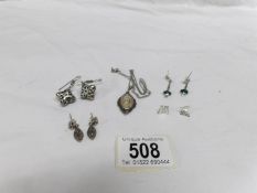 4 pairs of silver earrings and a silver pendant