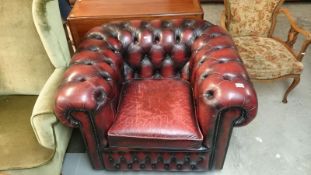 A burgundy deep buttoned 'Chesterfield' chair