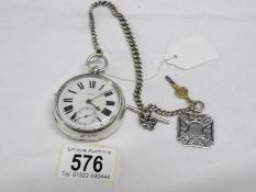 A silver chain driven pocket watch with silver chain and silver fob marked G Hewitt, Grimsby,