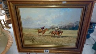 A gilt framed oil on board of horses and riders