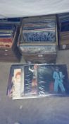 A box of classic rock LP records including several David Bowie, Deep Purple,