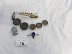 A set of gold scales 5 brass weights, a silver badge and a pill box
 
The name on the scales is B.