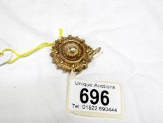 A Victorian 9ct gold brooch with gold safety chain,