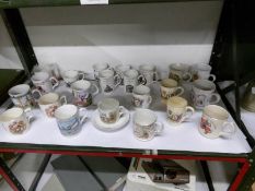 A collection of commemorative mugs