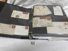 An album of 19th and 20th century envelopes affixed with stamps including British penny reds,