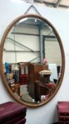 An oval bevel edged wall mirror,