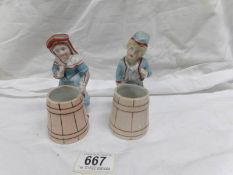 A pair of 19th century continental porcelain figure spill vases