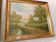 A gilt framed oil on canvas country cottage scene signed Robert Ixer