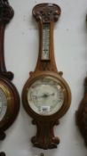 An oak aneroid barometer