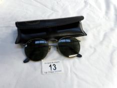 A pair of vintage Ray Ban sun glasses in case