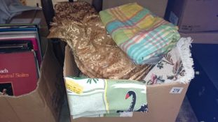 A box of table cloths and curtains etc