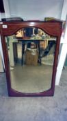An arts and crafts style bevel edged wall mirror