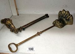 A brass foot doorstop and a pole screen frame