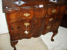 A 2 over 2 Queen Anne style chest of drawers with brass handles